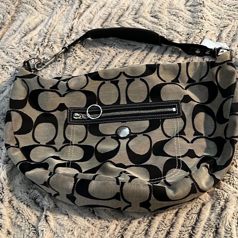Coach hobo bag with patten leather on handle and fixtures.